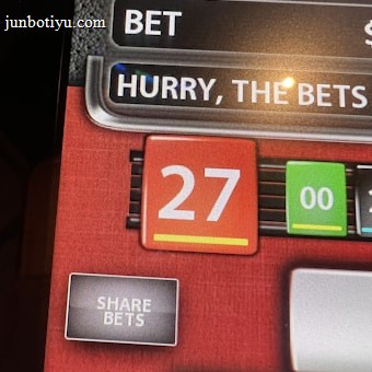A digital display screen showing a casino betting interface, with text prompting to hurry bets and a highlighted number 27 in red. There are options for betting amounts and a 'share bets' button.